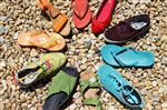 An array of brightly colored shoes in a circle with toes pointed toward the center